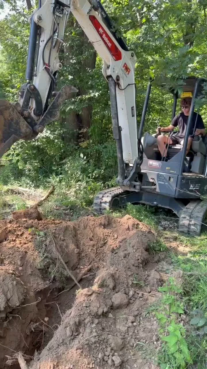 Excavator digging a trench