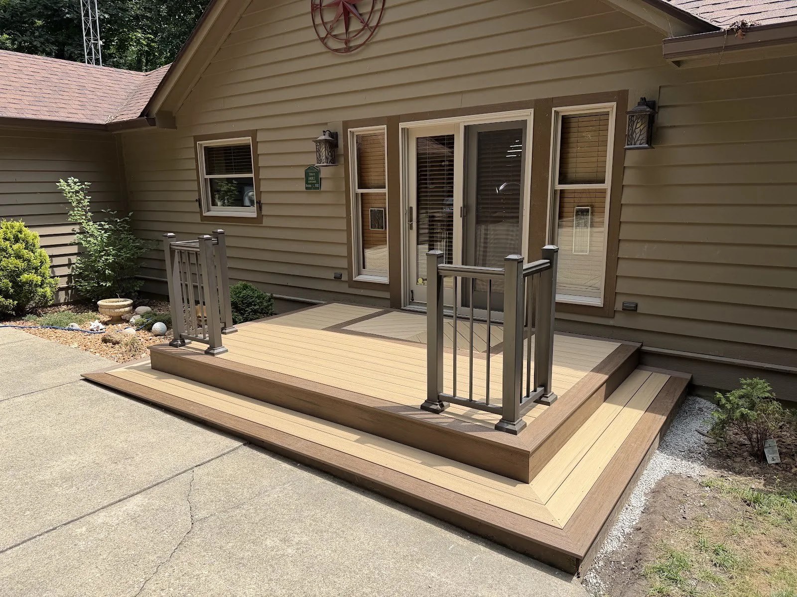 Composite front porch deck with railings and a picture-frame border.
